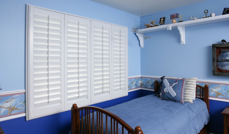 White plantation shutters in blue kids bedroom in Indianapolis 